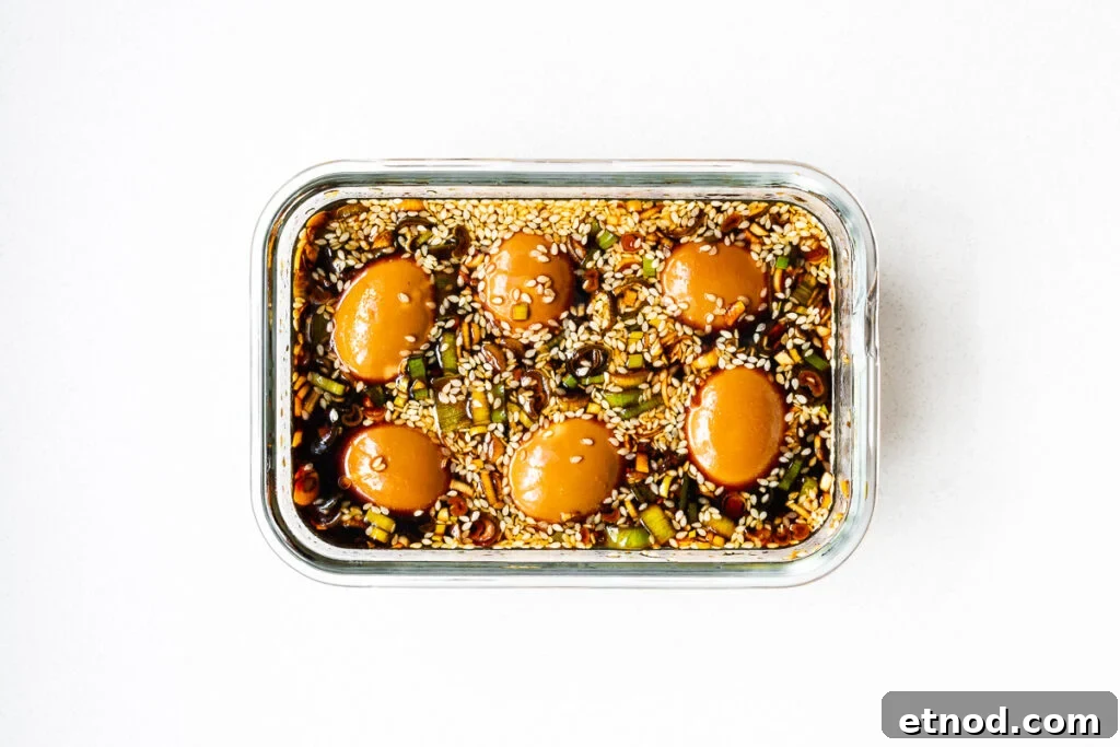 Mayak Eggs Recipe: Korean Soy-Marinated Soft-Boiled Eggs 11 Soy-marinated eggs in a glass container.