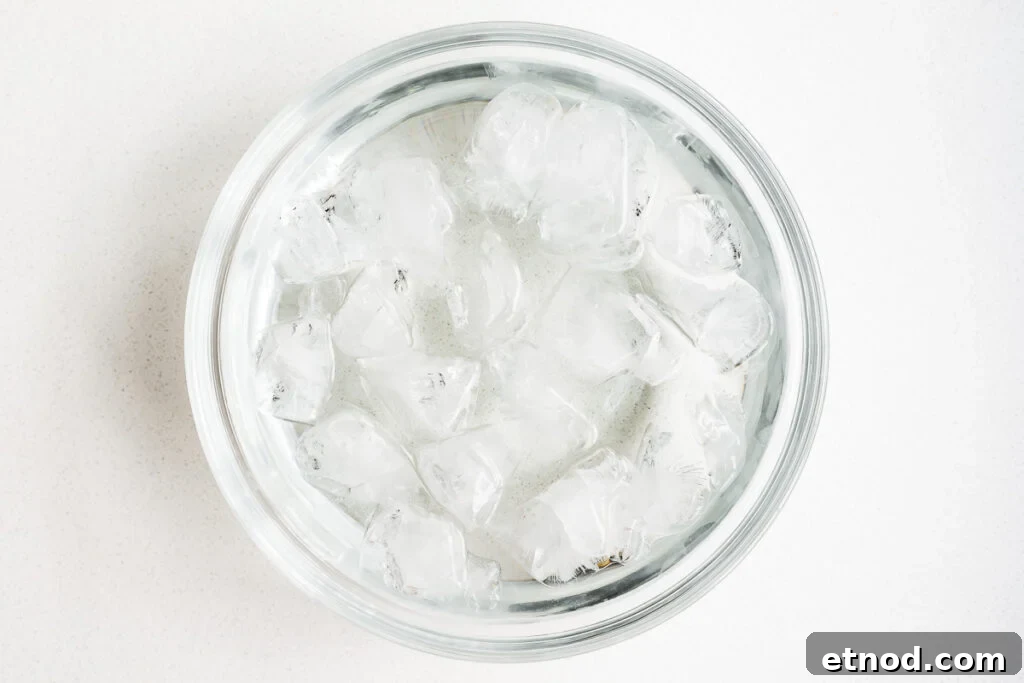 Mayak Eggs Recipe: Korean Soy-Marinated Soft-Boiled Eggs 5 An ice bath in a glass mixing bowl.