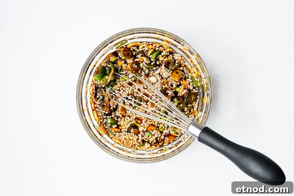 Mayak Eggs Recipe: Korean Soy-Marinated Soft-Boiled Eggs 9 A bowl of Korean egg marinade with a whisk.