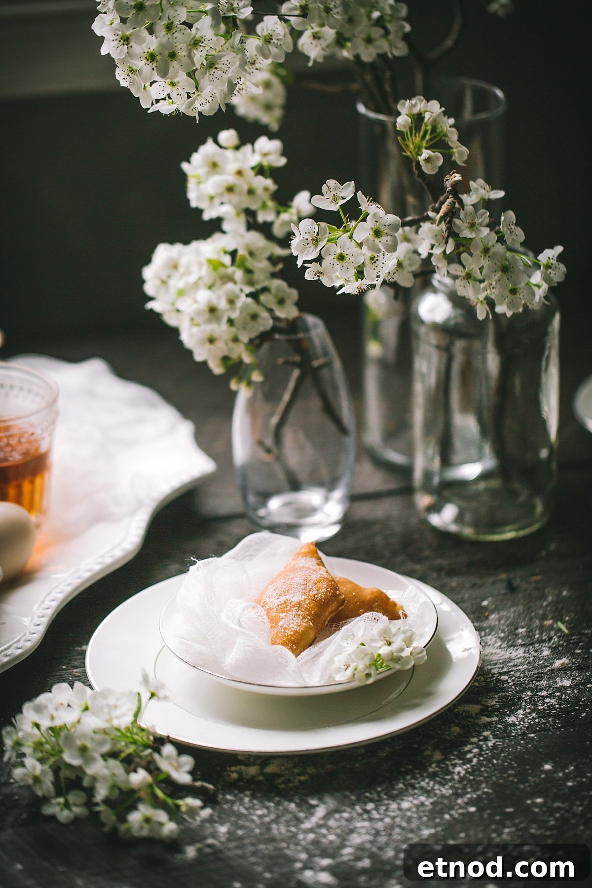 A faraway shot of two bugnes in a white bowl