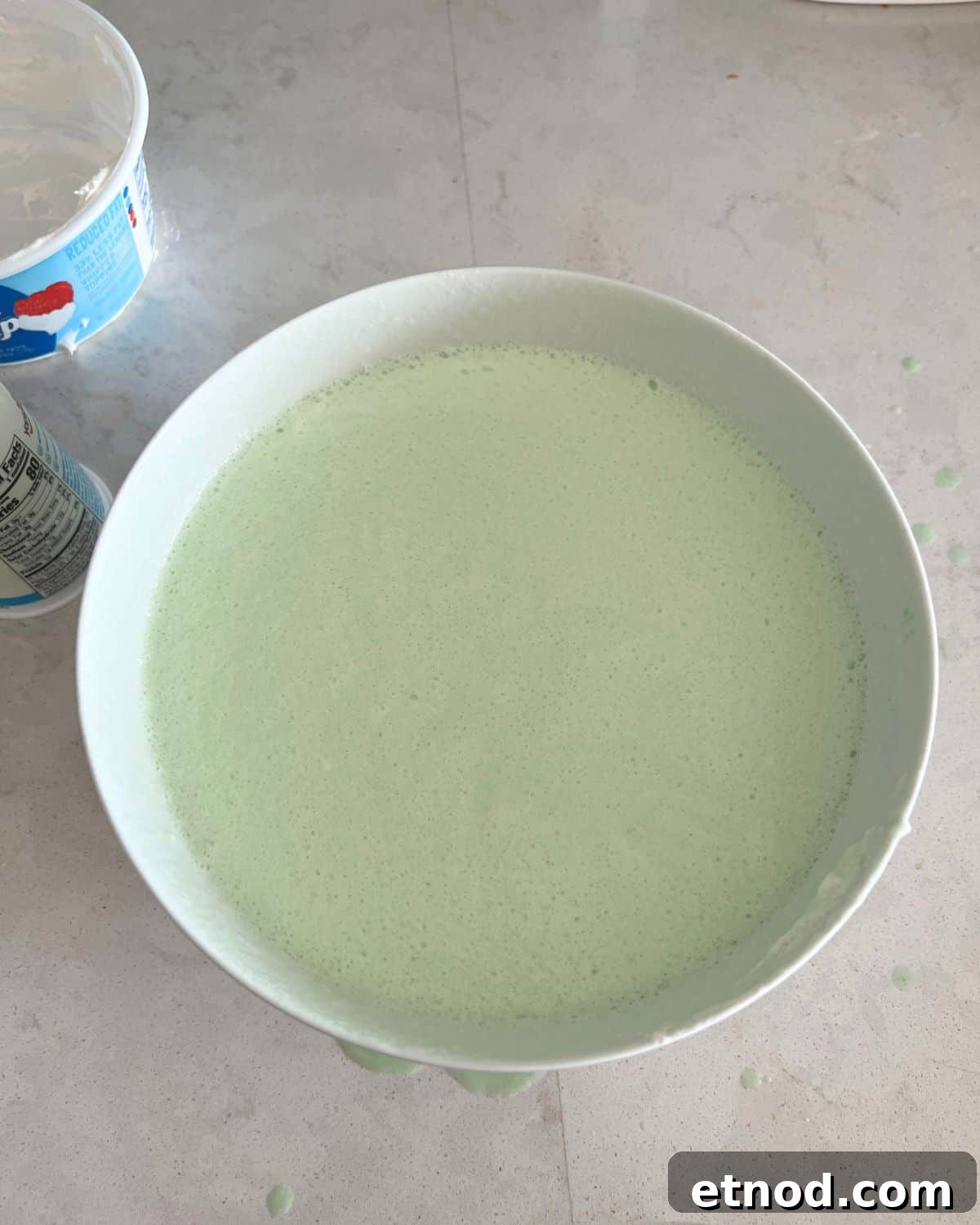 Lightened Key Lime Pie Recipe with Jell-O for Weight Watchers 5 Yogurt and Cool Whip combined in a bowl with gelatin.