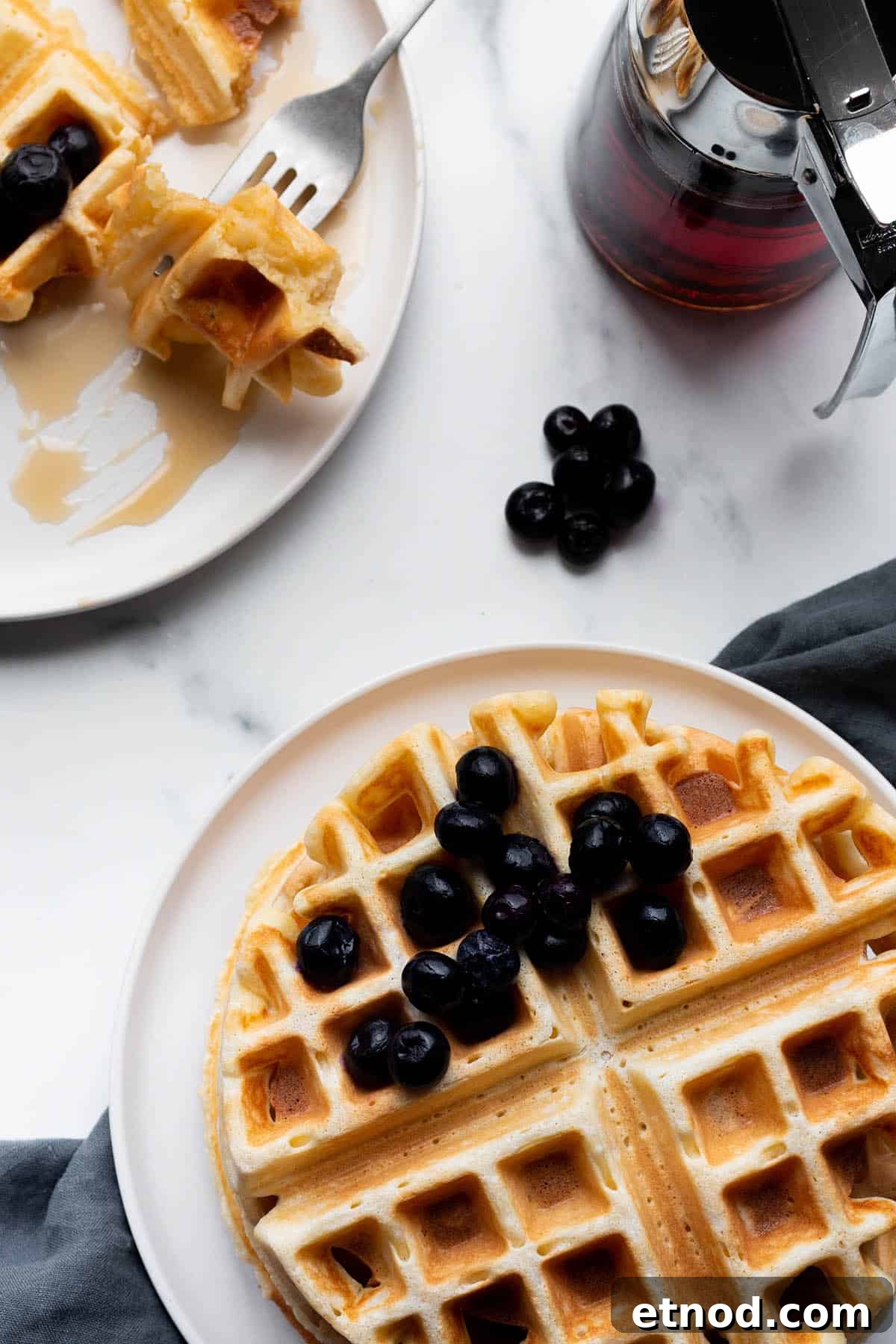 Crispy Sourdough Discard Waffles You’ll Want for Breakfast 6 Two plates with homemade sourdough waffles and blueberries.