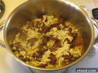 Greek Beef with Artichokes Recipe (Moschari me Agkinares) 9 Add onions to the browned beef for moschari-me-agkinares