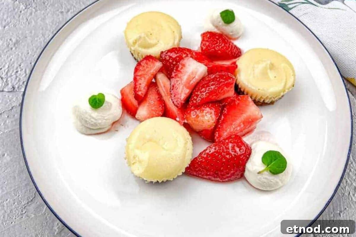 21 Quirky-Looking Desserts That Disappear First at Parties 13 A white plate with strawberries and mini biscoff cheesecakes.