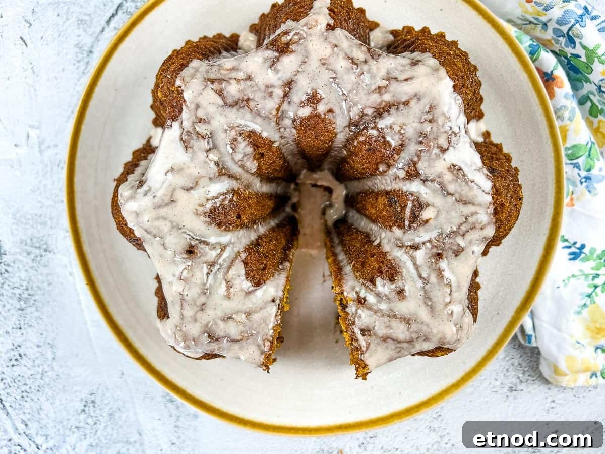 21 Quirky-Looking Desserts That Disappear First at Parties 15 Pumpkin Chocolate Cake on a white circular plate with gold rim.