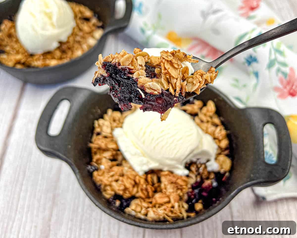 21 Quirky-Looking Desserts That Disappear First at Parties 16 A spoon lifts a portion of Smoked Berry Crisp from a bowl.