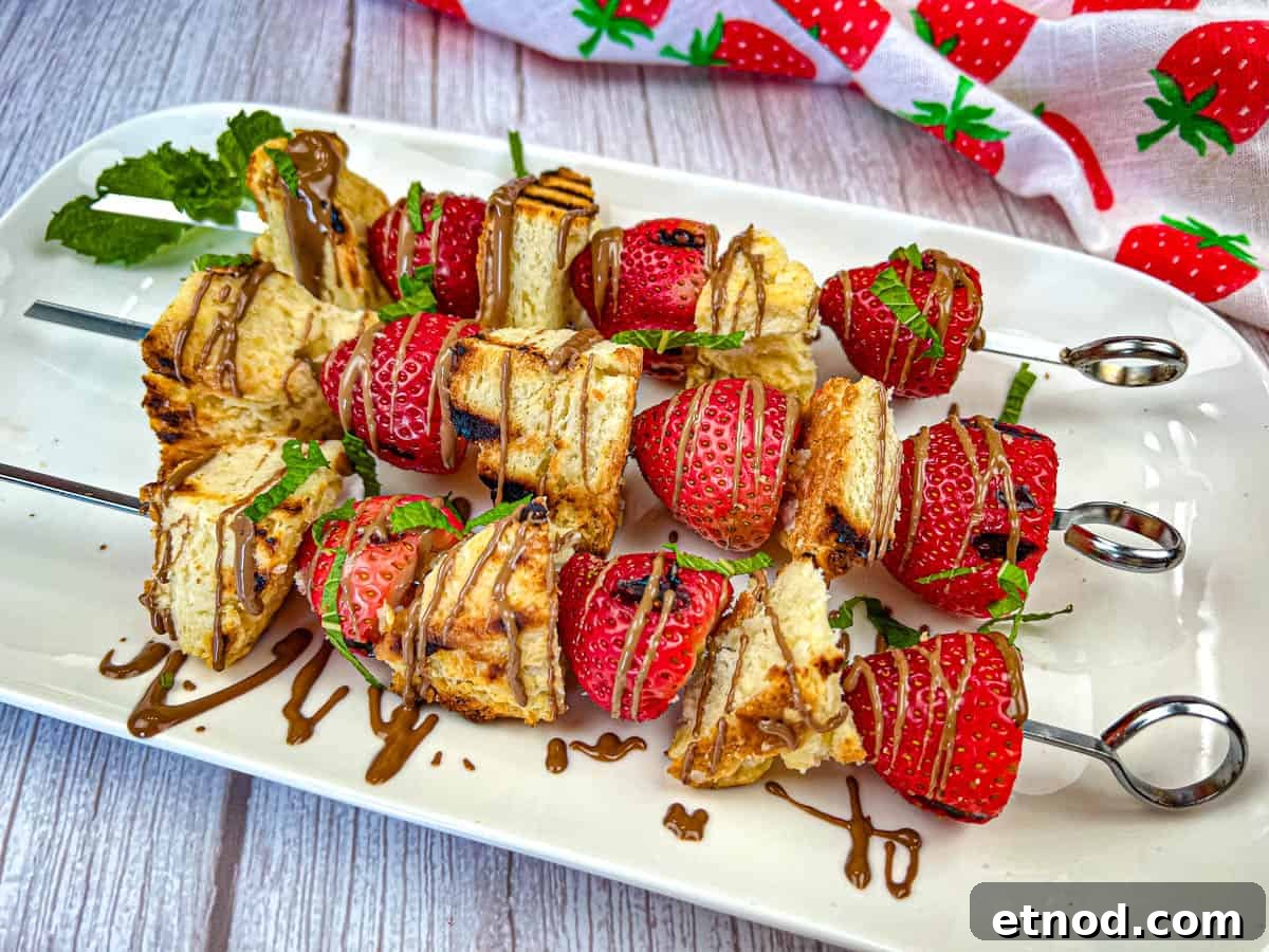 21 Quirky-Looking Desserts That Disappear First at Parties 4 Three pieces of Grilled Strawberry Shortcake Skewers on a white plate.