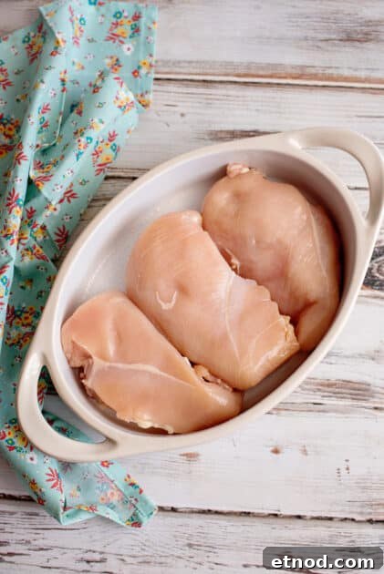 Place chicken breasts in baking dish.