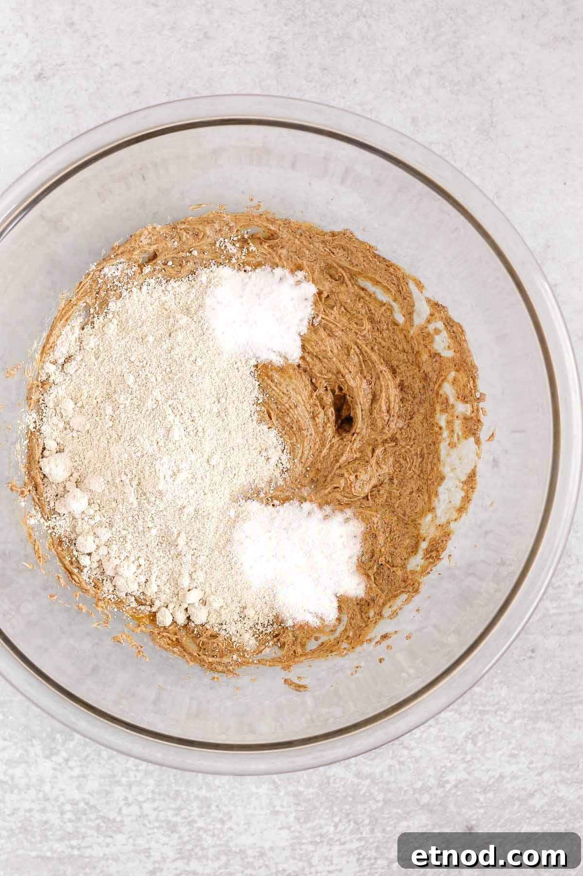 Oat flour cookie wet ingredients blended with oat flour, baking soda and tapioca flour added to the bowl.