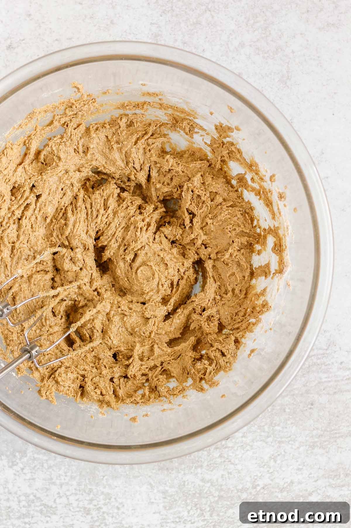 Oat flour cookie dough mixed in a large glass mixing bowl.