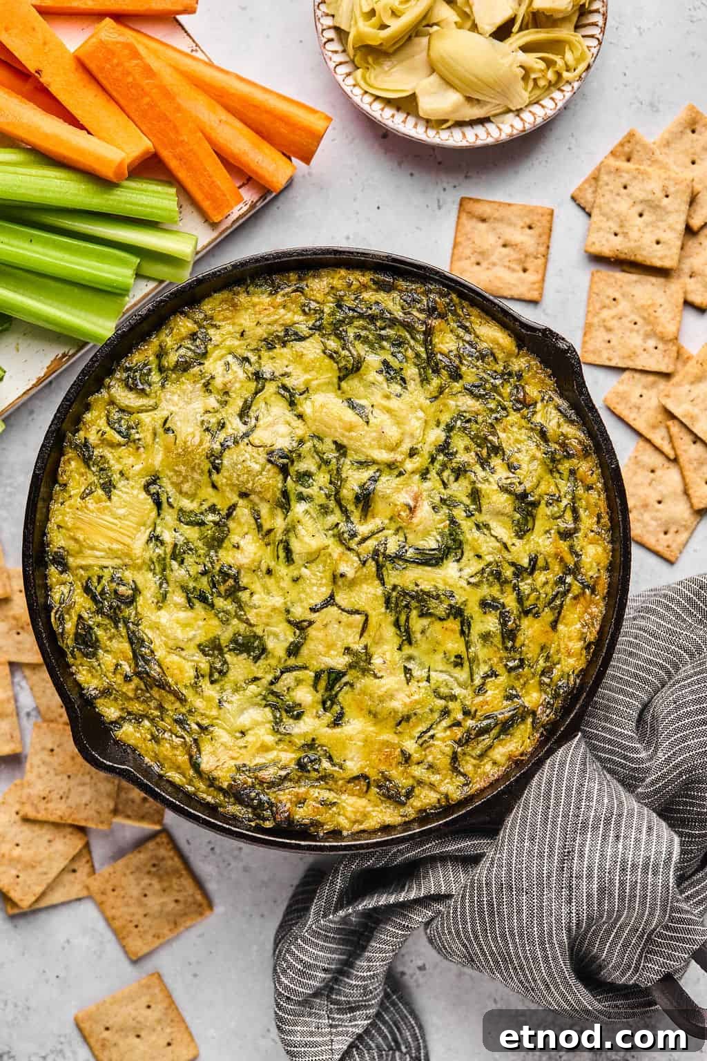 vegan spinach artichoke dip in a cast iron skillet.