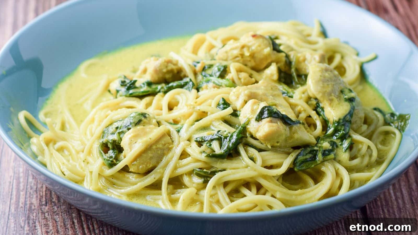 Spicy Chicken Curry Noodles with Coconut and Lime 3 a blue green bowl filled with chicken, spinach, noodles and curry sauce