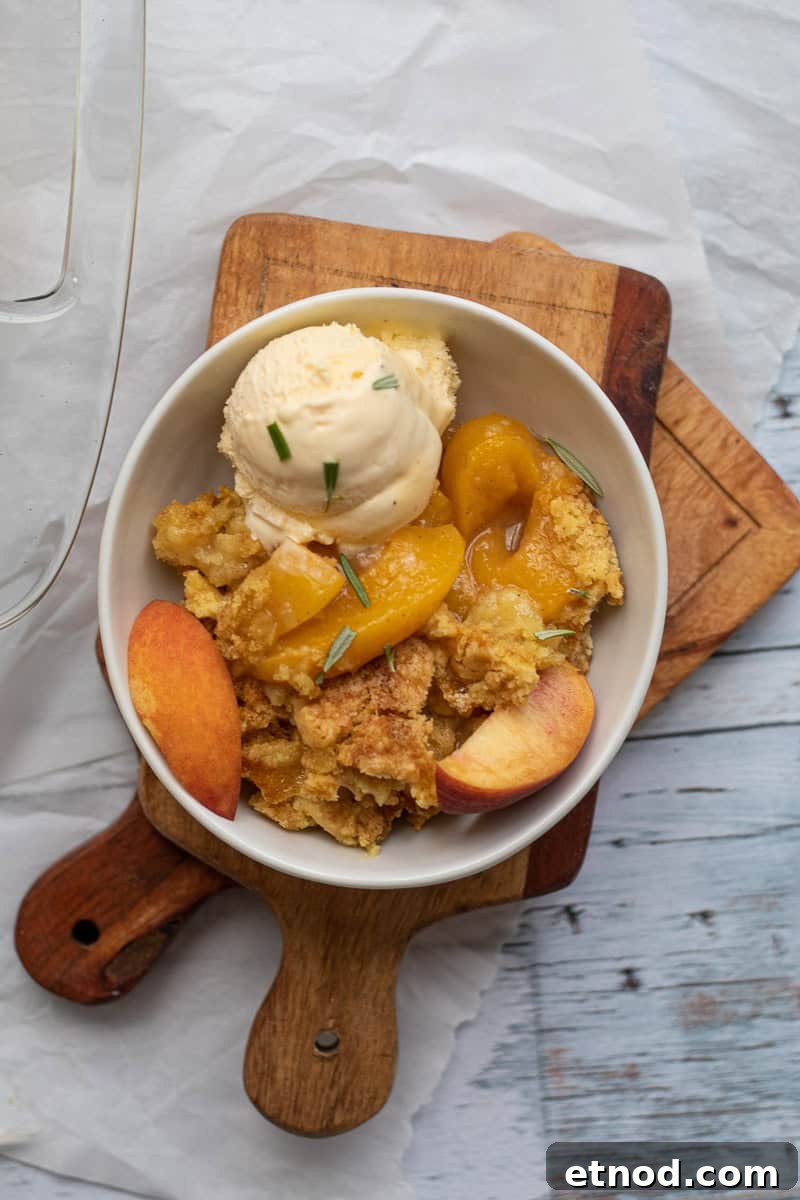 5-Ingredient Peach Cobbler Using Cake Mix Recipe 9 peach cobbler with a scoop of vanilla ice cream