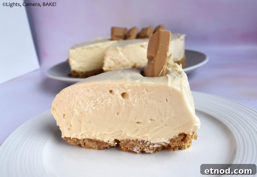 Slice of caramilk cheesecake on white plate.