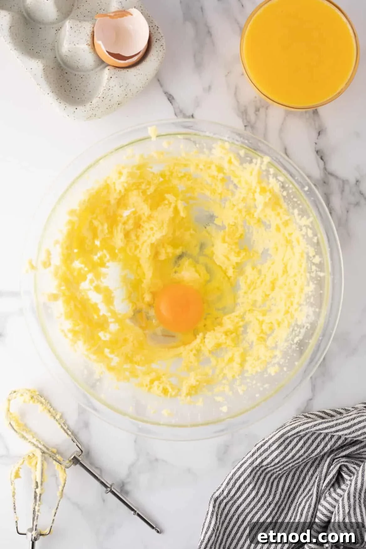 Lemon Curd Thumbprint Cookies — Zesty Jam-Filled Shortbread 5 Overhead view of mixing bowl with one egg added to the center.