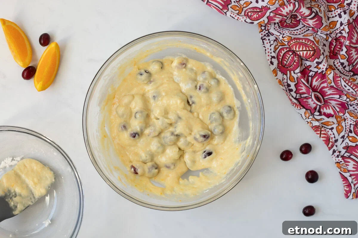 Orange Cranberry Bread Batter for cranberry orange quick bread in mixing bowl after dry and wet ingredients are gently folded together.